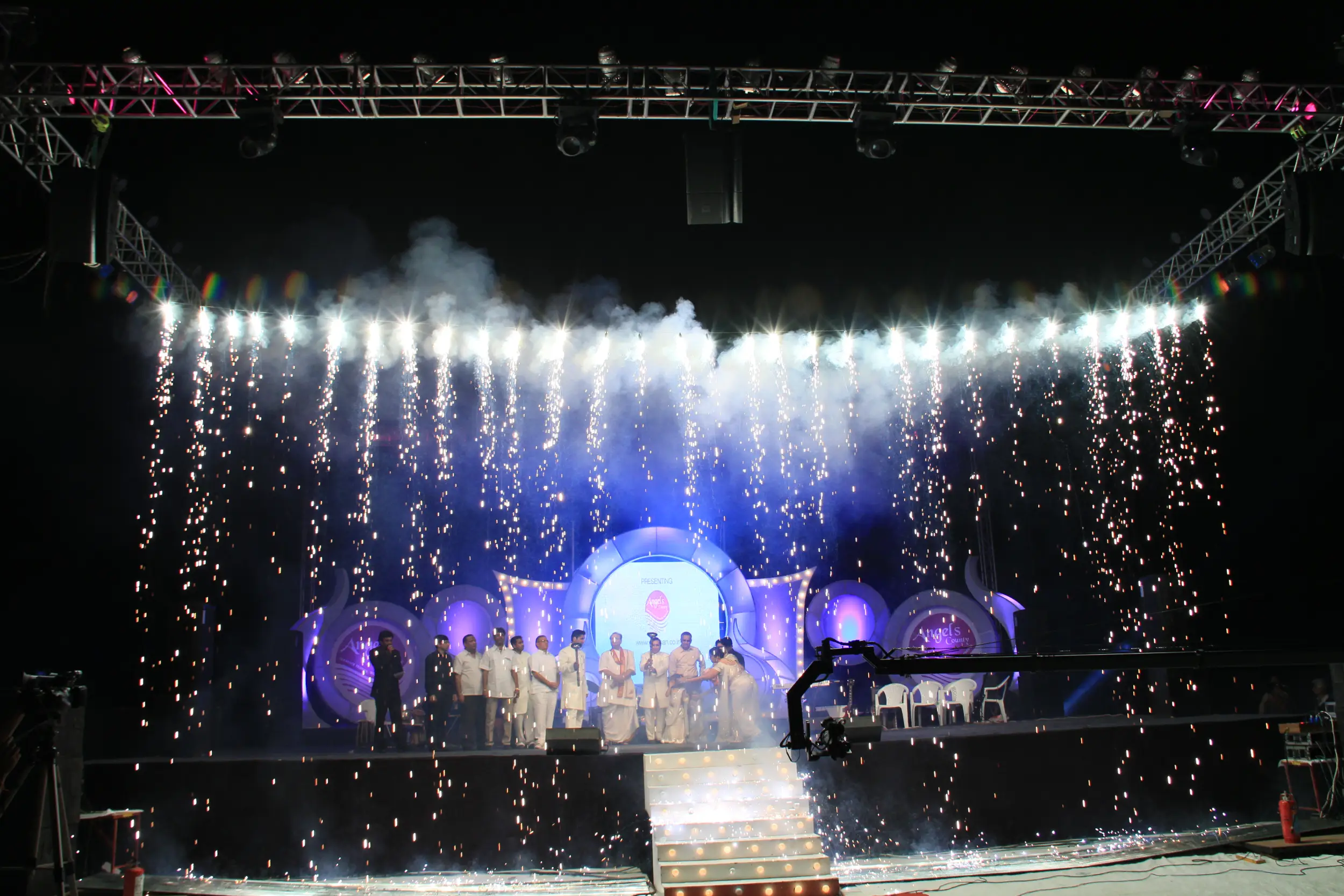 Group of men posing with large cartoon character inflatable figures at night outdoors
